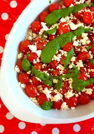 A picture of Blistered tomato, feta and basil & morogo pesto salad.