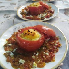 A picture of Baked egg in tomato cups.