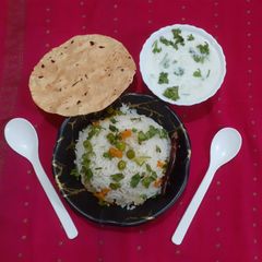A picture of Biryani with Raita.