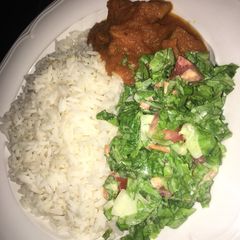 A picture of Rice with stew and salad.