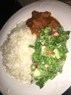 A picture of Rice with stew and salad.