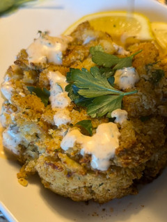 A picture of Baked crab cakes / Cajun dill sauce.