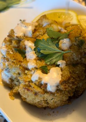 A picture of Baked crab cakes / Cajun dill sauce.