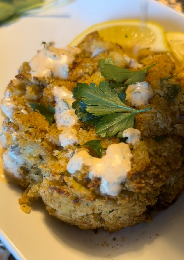 A picture of Baked crab cakes / Cajun dill sauce.