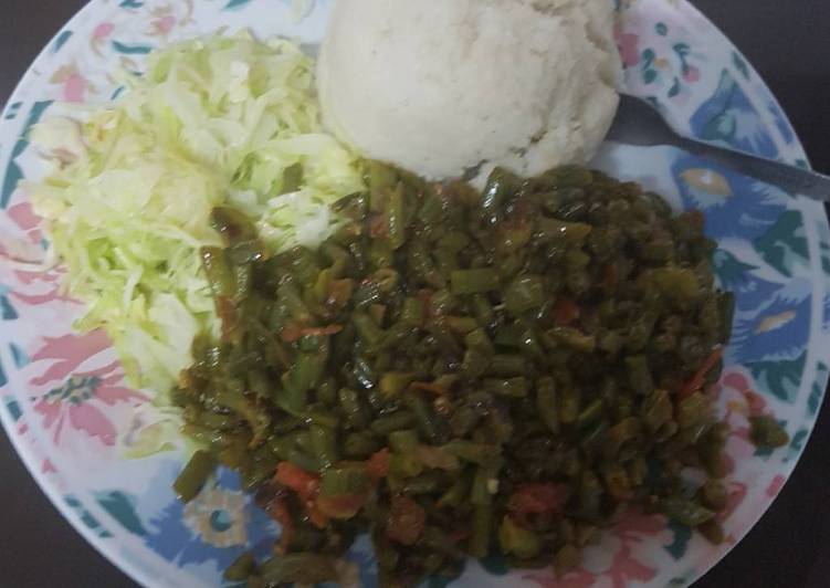 Ugali served with fried French beans and steamed cabbage