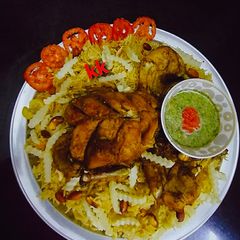 A picture of Chicken Mandi with kabsa rice.
