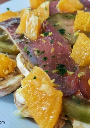 Una foto de Ensalada de tomate, champiñón y mojama con cítricos