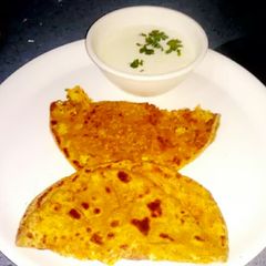 A picture of Gobhi parantha with curd.