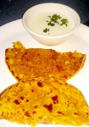 A picture of Gobhi parantha with curd.