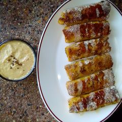 A picture of Banana French toast roll ups with peanut sauce. #breakfastideas.