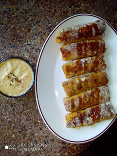 A picture of Banana French toast roll ups with peanut sauce. #breakfastideas.