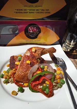 A picture of Golden chicken with veggies.
