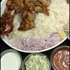 A picture of Mutton roasted tandori leg with simple zeera rice.