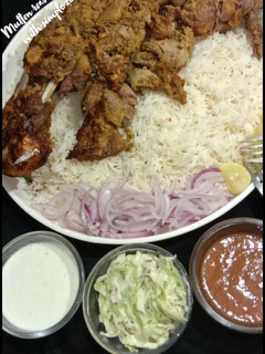 A picture of Mutton roasted tandori leg with simple zeera rice.