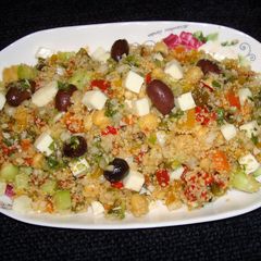 A picture of Whole wheat couscous salad with roasted peppers and feta cheese.