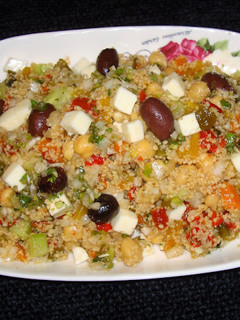 A picture of Whole wheat couscous salad with roasted peppers and feta cheese.