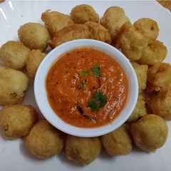 Urad daal pakoda with tomato onion chutney A picture of Urad daal pakoda with tomato onion chutney.