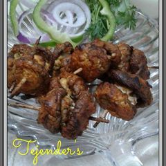 A picture of Paneer stuffed mushroom lollipops.
