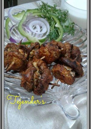 A picture of Paneer stuffed mushroom lollipops.
