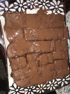 A picture of Fudgy brownies with melted chocolate.