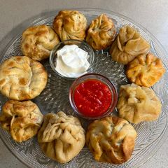A picture of Wheat base Momos with red hot chutney.