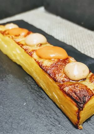 A picture of Layered Potatoes with Spicy Sauce and Black Garlic Aioli.