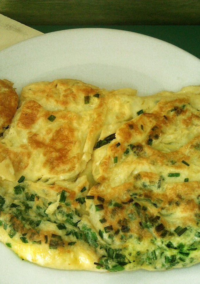 Una foto de Tortilla asiática con cebollinos