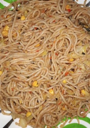 A picture of Jollof spaghetti with veggies.