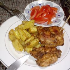 A picture of Baked Potatoes and Chicken.