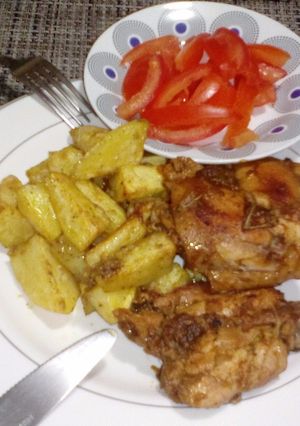 A picture of Baked Potatoes and Chicken.