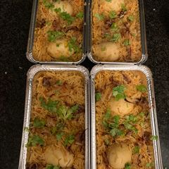 A picture of Egg Briyani with Raita.