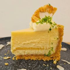 A picture of PIÑA COLADA CHEESECAKE (with a pineapple insert inside the cheesecake).