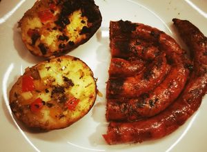 Una foto de Salchicha parrillera con papas al plomo en estufa a leña