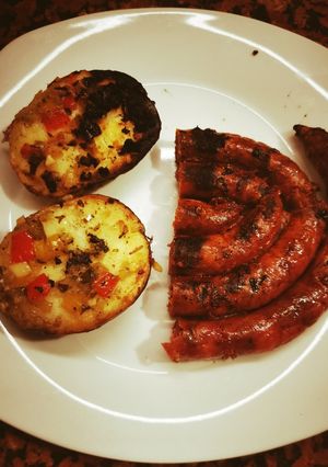 Una foto de Salchicha parrillera con papas al plomo en estufa a leña