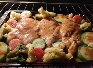 A picture of Baked Italian chicken breast with roasted veggies.