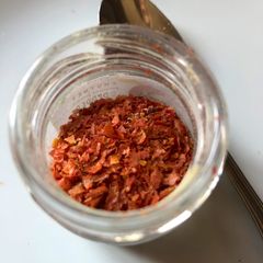 A picture of Tomato peels in a jar.