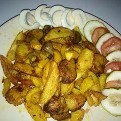 A picture of Fried chips and plantain in kidney sauce.