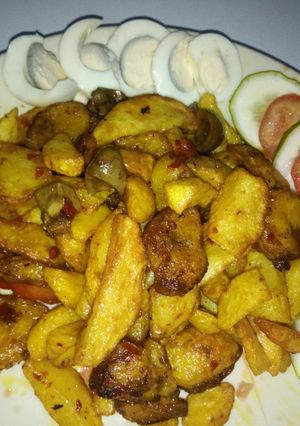 A picture of Fried chips and plantain in kidney sauce.
