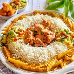 A picture of Saucy Crispy chicken with rice fries and vegetable.