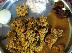 A picture of Mutton Biryani with mutton gravy and chicken 65.