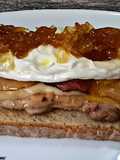 Tosta de pollo con queso, bacon, huevo frito y cebolla caramelizada