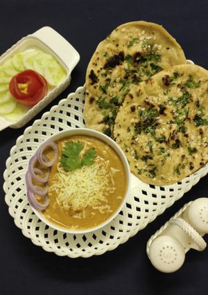 A picture of Cheese butter masala and garlic naan.