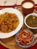 Punjabi thali (chole with rice, creamy Palak paneer, spicy onion lachcha and refreshing lassi)