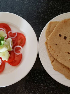 A picture of Simple salad with flat bread roti.