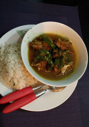 A picture of Ofada rice with chicken pepper soup.