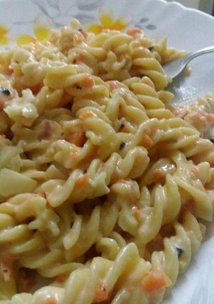 A picture of Fusilli pasta in white sauce.