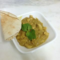 A picture of Chicken baked in a buttery curried apple sauce.