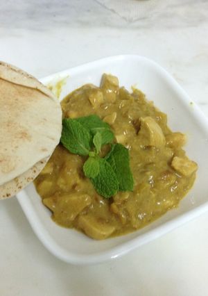 A picture of Chicken baked in a buttery curried apple sauce.