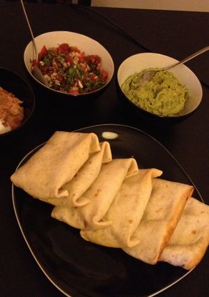 A picture of Beef Chimichangas with Pico De Gallo, Guacamole & Sour Cream.