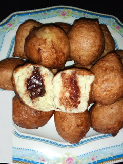 A picture of Puff puff filled with dark chocolate.